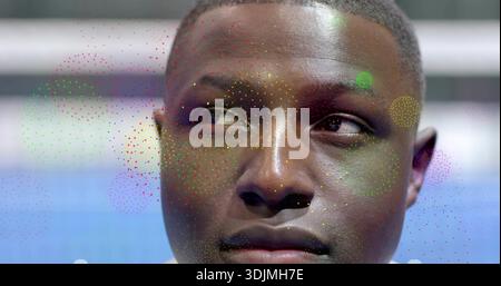 Glancing man showing thoughtful look in studio, with multicolored dot overlay, shirt collar visible Stock Photo