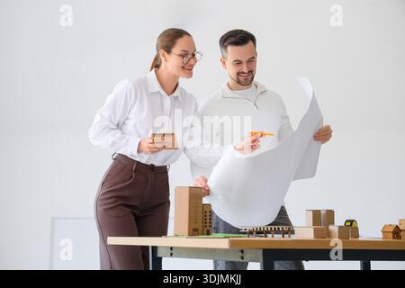 Young architects working with house plan in office Stock Photo