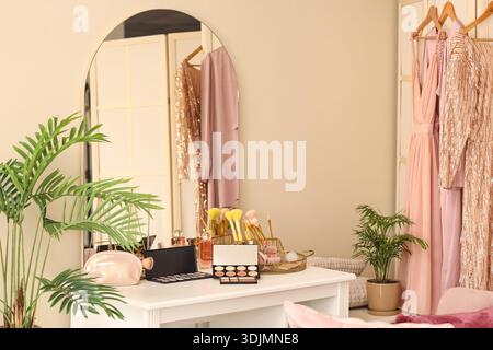Makeup products on table in dressing room Stock Photo