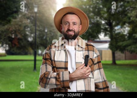 Man with hidden spy camera in his pocket outdoors Stock Photo