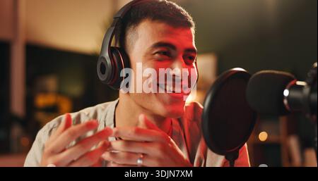 Content creator, man and microphone for podcast, recording or night broadcast for radio host dj. Live streaming, headphones or streamer reading script Stock Photo