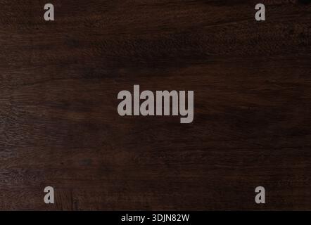 Rich dark brown wood grain texture from large natural tree trunk. High-resolution timber surface features organic patterns perfect for rustic backgrou Stock Photo