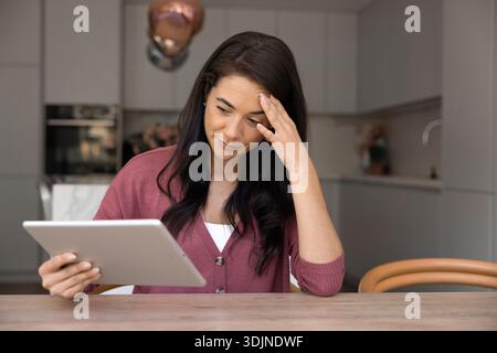 Woman experiencing problems with digital tablet device Stock Photo
