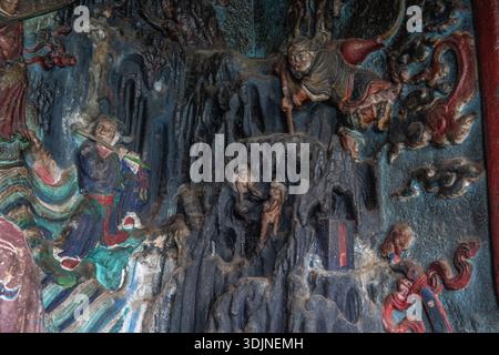 A stone carving depicting a scene near the dragon gate in Kunming, Yunnan, China. Stock Photo