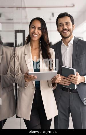 Happy young, professional multiethnic teammates posing in workspace Stock Photo