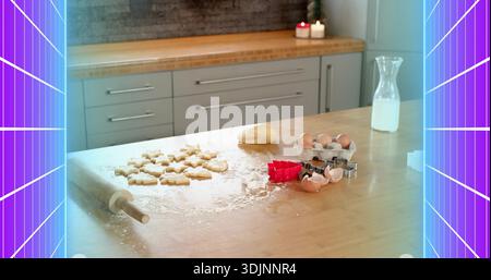 Preparing home baking showing rolling pin, cookie cutters, eggs and milk on worktop, candles Stock Photo
