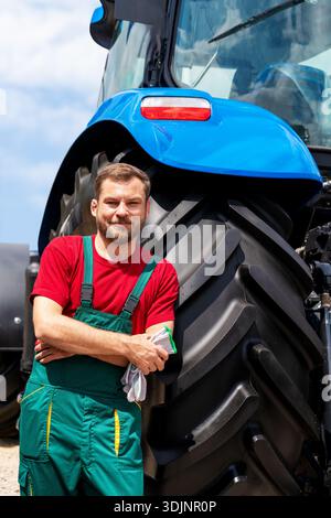 Portrait of smiling male farmer leant on tractor outdoors Stock Photo