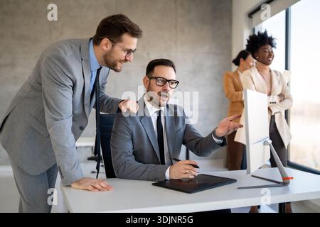 Multicultural business professionals in office, teamwork to achieve corporate success together Stock Photo