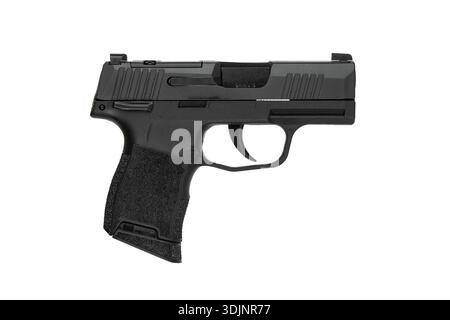 Compact black semi-automatic 9mm pistol isolated on a clean white background. Stock Photo