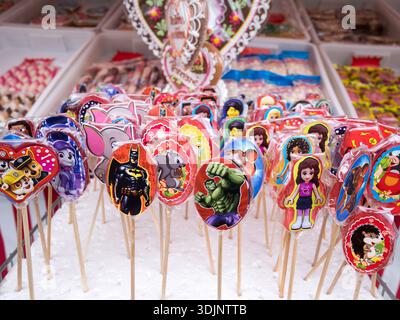 Colorful lollipops, cartoon heroes, for sale on a market stall display Stock Photo