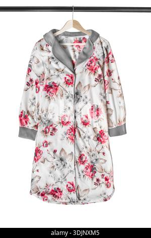 Fleece floral print bathrobe hanging on clothes rack isolated over white Stock Photo