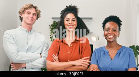 Friendly Trio Of Diverse Colleagues Smiling In A Modern Office For Teamwork And Collaboration Stock Photo