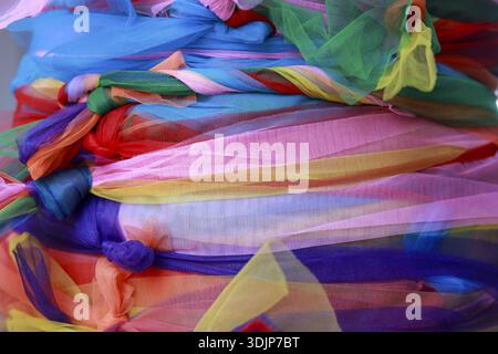 Vibrant, colorful abstract background of soft tulle fabric. sheer, flowing material creates joyful and playful texture, perfect for celebration or cre Stock Photo