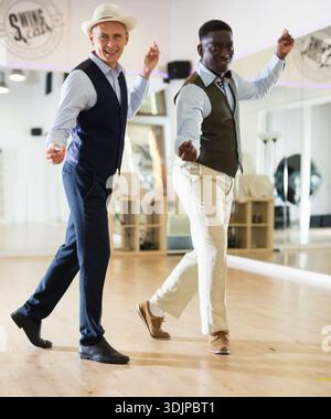 Two professional dancers practicing lindy hop in dance class Stock Photo