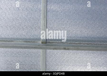 Abstract geometric background featuring translucent polycarbonate sheet texture on roof showing sturdy metal structure and linear pattern conveying co Stock Photo