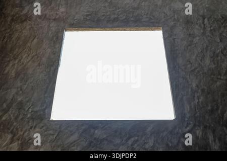 Top view of blank white paper sheet with clean rectangular frame on textured dark gray fabric background inviting calm creative concept design or arti Stock Photo