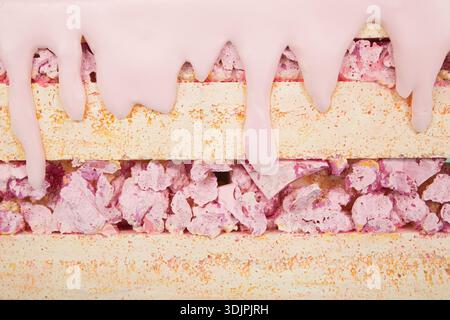 Artificial sweets crafted from polystyrene foam, featuring layers of pink icing and colorful sprinkles, arranged on a flat surface with a textured bac Stock Photo