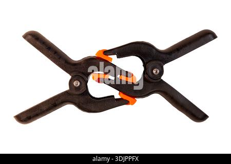 Two black spring clamps interlocked with orange pivoting jaw pads Stock Photo