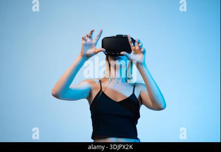 Virtual reality experience with woman using VR headset, interactive technology and metaverse concept Stock Photo