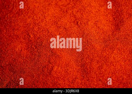 intense paprika powder color background, dense granular surface with saturated redorange hues, perfect for packaging mockups, poster layouts, textile Stock Photo