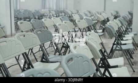 Folding chairs, a type of furniture that many people like because of its compact, strong nature, the chairs are arranged neatly in several rows, gray Stock Photo