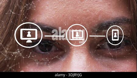 Showing mid-adult face displaying network over eyes-brows in studio with desktop-laptop-phone icons Stock Photo