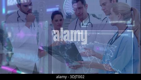 Analyzing medical team studying tablet and hologram in clinic, wearing lab coats and stethoscopes Stock Photo