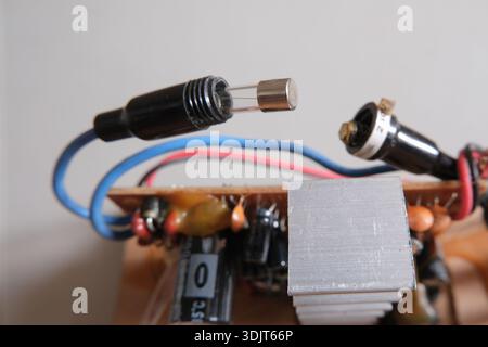 Glass fuse on an electrical circuit. Cartridge-type fuse in portable socket. Stock Photo