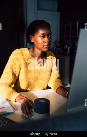 Focused female young programmer working on computer in office Stock Photo