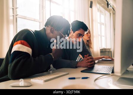 Focused male business professionals working in tech office Stock Photo