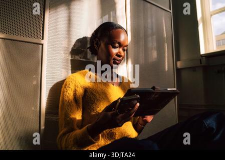 Female business expert using tablet PC while sitting in office Stock Photo
