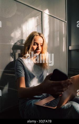 Focused young female business professional using laptop while sitting in office Stock Photo