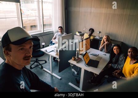 High angle view of male business expert sharing ideas with team in meeting at startup office Stock Photo