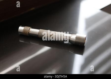 A small metallic used and dirty flashlight Stock Photo
