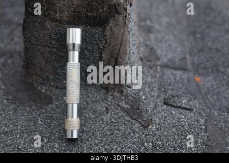 A small metallic used and dirty flashlight Stock Photo