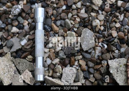A small metallic used and dirty flashlight Stock Photo