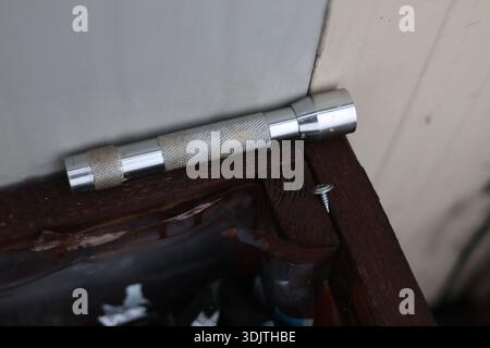 A small metallic used and dirty flashlight Stock Photo