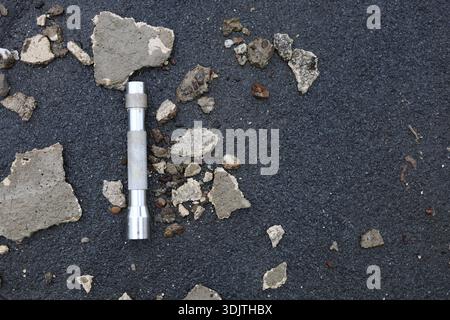 A small metallic used and dirty flashlight Stock Photo