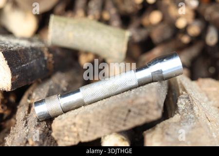 A small metallic used and dirty flashlight Stock Photo