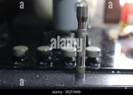 A small metallic used and dirty flashlight Stock Photo