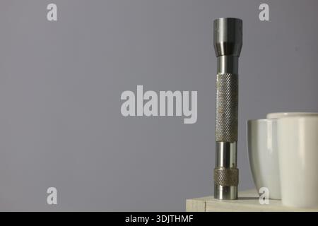 A small metallic used and dirty flashlight Stock Photo