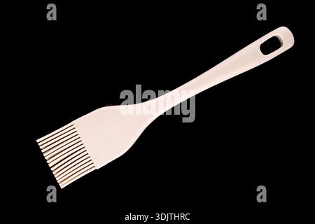 Silicone pastry brush on a black background, close-up, top view. Stock Photo