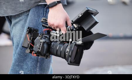 Handheld camera rig filming video production with professional cinematography gear Stock Photo