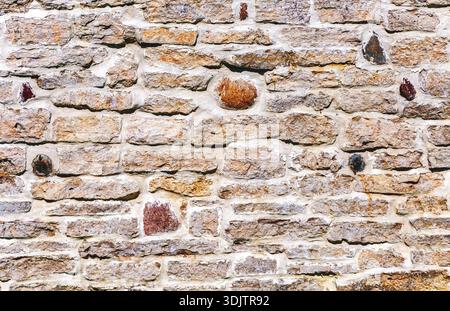 Weathered grey stone wall as creative background texture Stock Photo