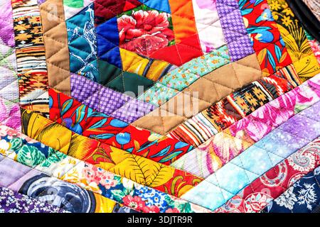 Multicolored creative background from handmade multicolor doormat. Texture of rug from different colorful fabrics Stock Photo