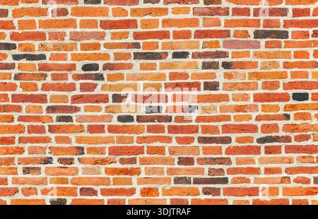 Weathered red brick wall as creative background texture Stock Photo