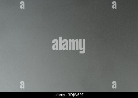 Focus is on a dark gray surface with a smooth texture and a gradient that transitions from light to dark. Stock Photo