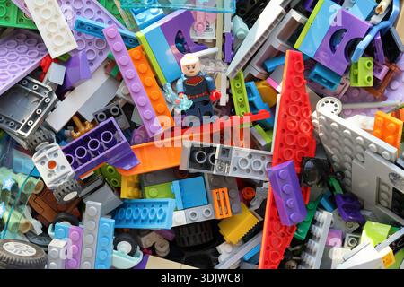 Lego pieces mixed in different colors and shapes. Top view photo. Stock Photo
