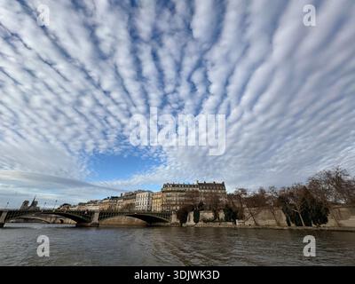 Altocumulus undulatus clouds above the  Seine River in the  the heart of Paris, France Stock Photo