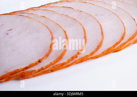 catering sliced meat for charcuterie boards on white background, uniform slices with seasoned edge, perfect for events, platters and hospitality displ Stock Photo